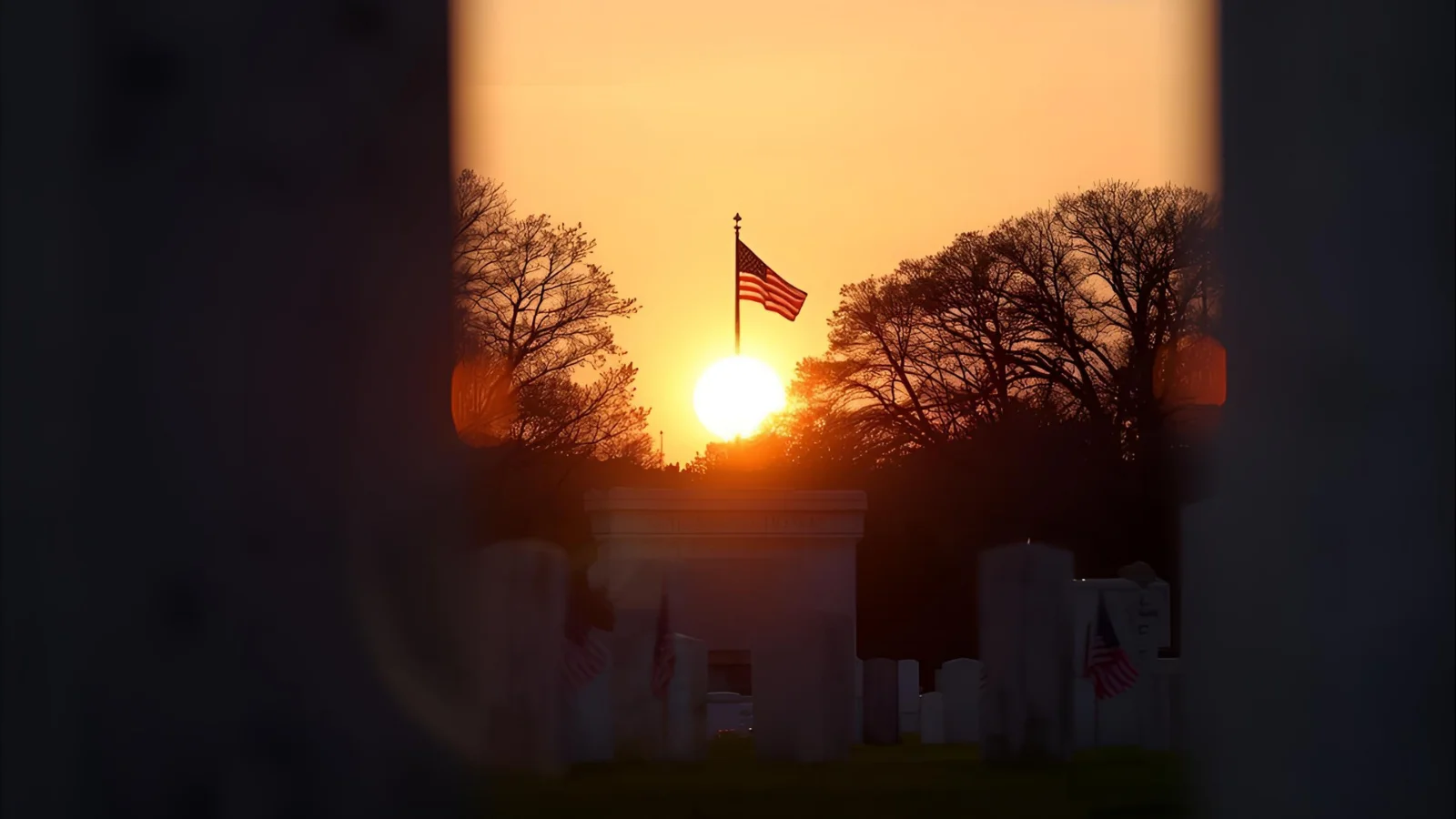 Sunrise at Arlington on Veterans Day with U.S. flags and memorial.